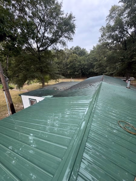 Metal roofing panels after soft washing by Premier Shine Wash Co.
